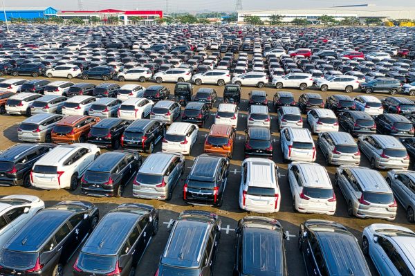 From above of rows with many modern new shiny automobiles of contemporary industry in daytime