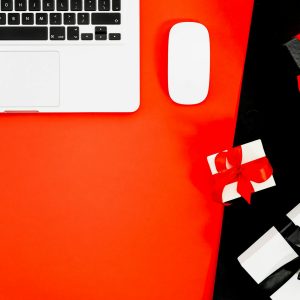 Macbook Pro And Gift Boxes On Red And Black Background